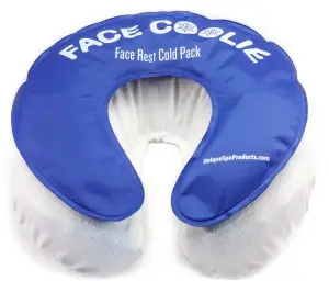 Cooled face cradle applied to massage therapy client for relaxation