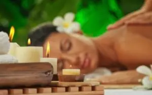 Woman getting a relaxing massage with candles