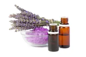 Bottle of lavender essential oil with flowers 