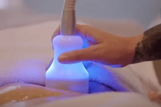 Non-invasive massage device in use for body sculpting at a spa